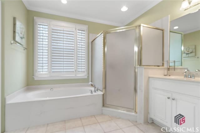 full bath featuring vanity, ornamental molding, a shower stall, and a garden tub