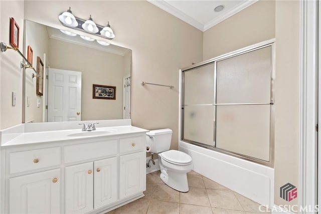 full bath with crown molding, tile patterned floors, vanity, combined bath / shower with glass door, and toilet