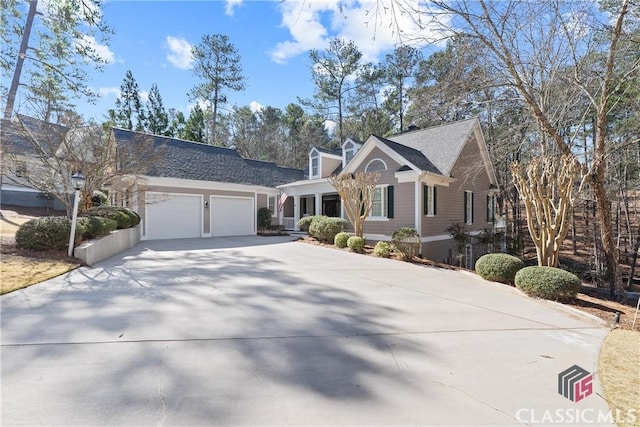 view of front of property with concrete driveway and a garage