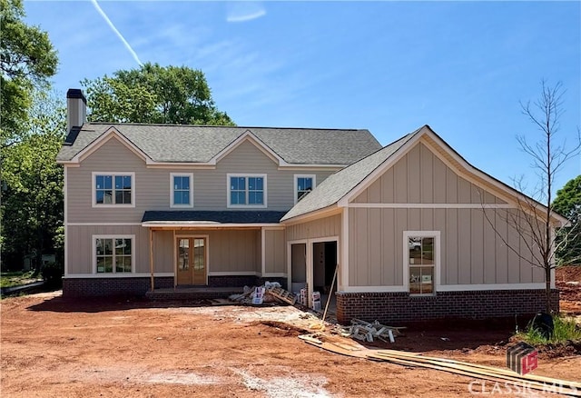 88 Morrison St Unit 56, Watkinsville, GA 30677 - view of front of property featuring a chimney, french doors, brick siding, and roof with shingles