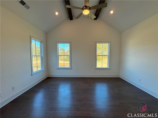 unfurnished room featuring vaulted ceiling with beams, visible vents, dark wood-style flooring, and a wealth of natural light