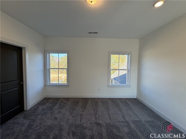 88 Morrison St Unit 56, Watkinsville, GA 30677 - spare room featuring dark colored carpet, a healthy amount of sunlight, baseboards, and visible vents