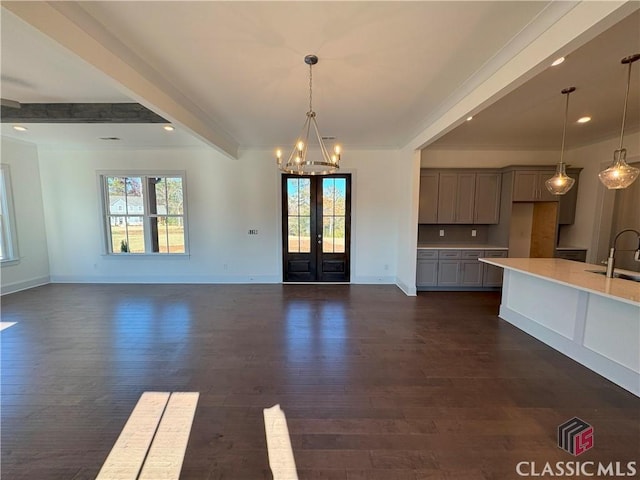 interior space featuring a sink, french doors, beamed ceiling, and dark wood finished floors