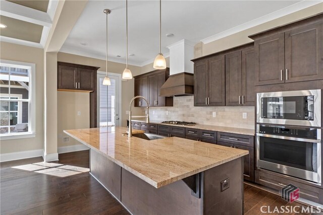 1380 Melody Bnd Unit 45, Watkinsville, GA 30677 - kitchen with tasteful backsplash, a sink, premium range hood, dark brown cabinetry, and dark wood-style floors