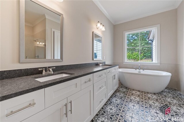 1380 Melody Bnd Unit 45, Watkinsville, GA 30677 - full bath featuring a freestanding bath, a sink, crown molding, double vanity, and tile patterned floors