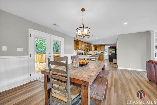 dining room featuring french doors, recessed lighting, visible vents, light wood-style flooring, and wainscoting