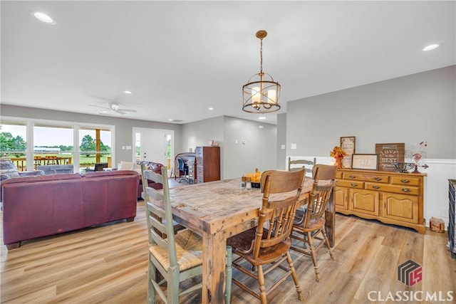 dining room with recessed lighting, light wood-style flooring, and ceiling fan with notable chandelier