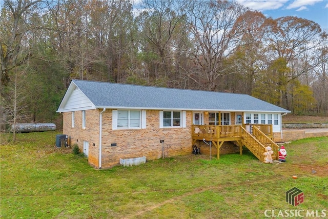 ranch-style house with crawl space, central air condition unit, stairs, and a front lawn