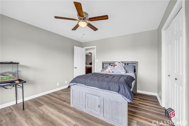 bedroom featuring a closet, ceiling fan, baseboards, and wood finished floors