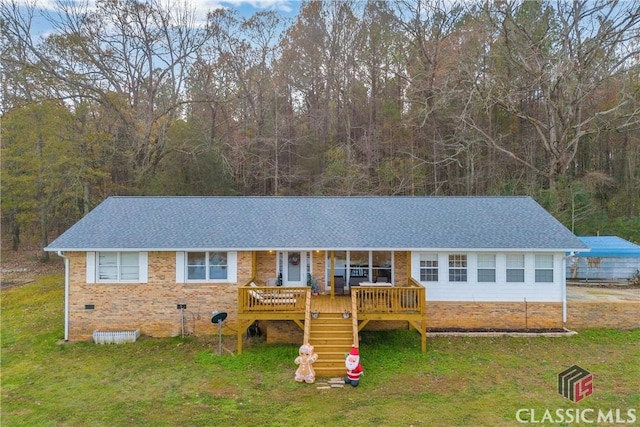 ranch-style home featuring a shingled roof, crawl space, a front yard, and stairway