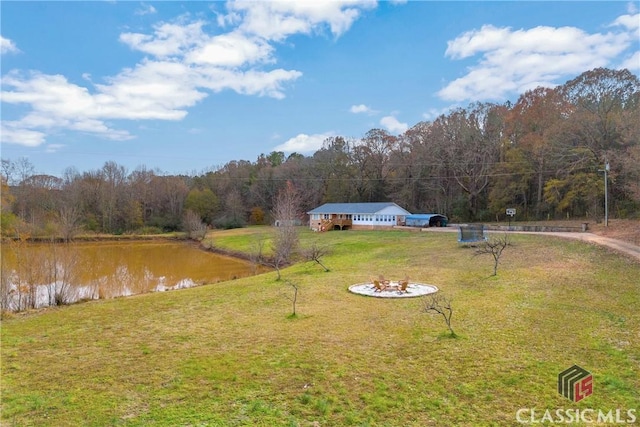 view of yard featuring a water view and a wooded view