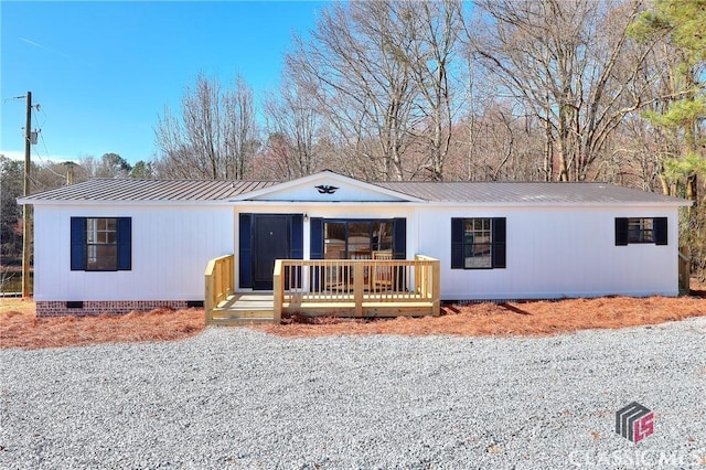 view of front of house with crawl space and metal roof