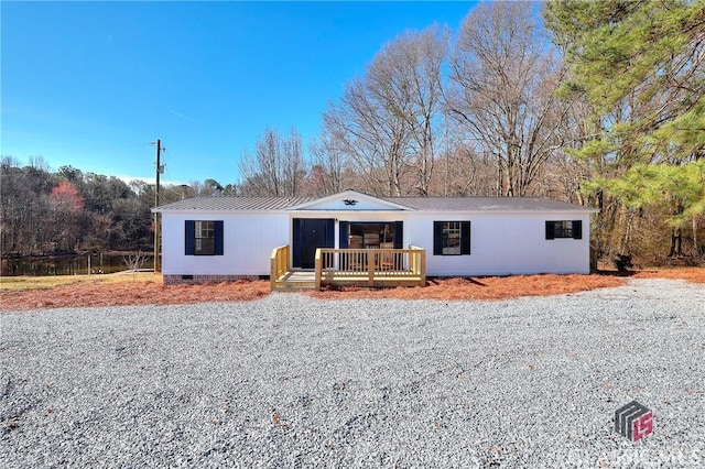 view of front of home featuring metal roof and crawl space