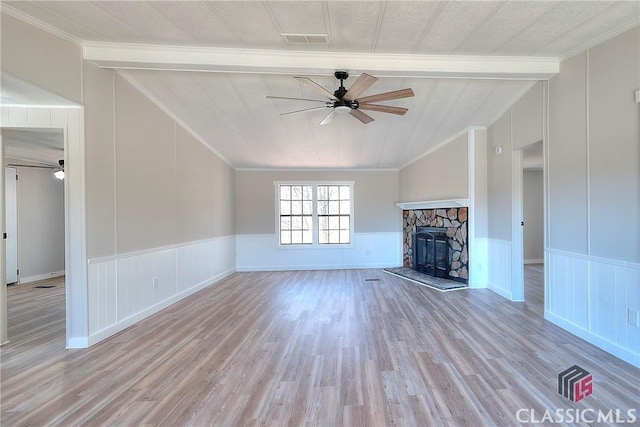 unfurnished living room featuring a ceiling fan, vaulted ceiling, a fireplace, and ornamental molding