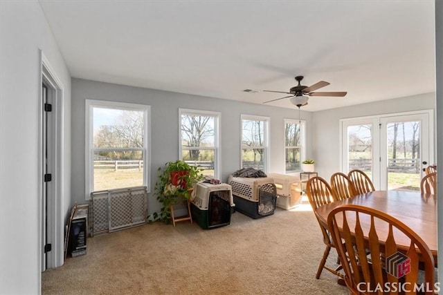 sunroom / solarium with visible vents and a ceiling fan