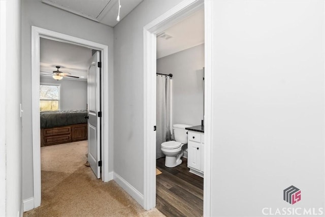 bathroom with visible vents, baseboards, toilet, ceiling fan, and vanity