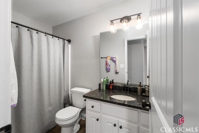 bathroom featuring vanity, toilet, and a shower with curtain