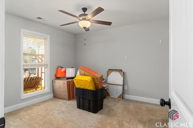 carpeted bedroom featuring baseboards, visible vents, and a ceiling fan