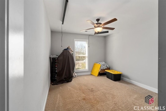 recreation room with a ceiling fan, baseboards, and carpet flooring