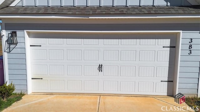 garage featuring concrete driveway