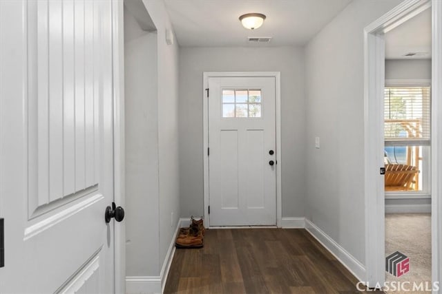 doorway to outside featuring dark wood-style floors, visible vents, and baseboards