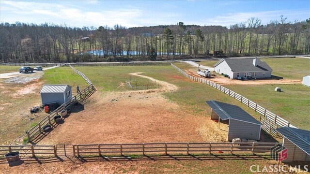 view of outdoor structure with a rural view, an outbuilding, an exterior structure, and a detached carport