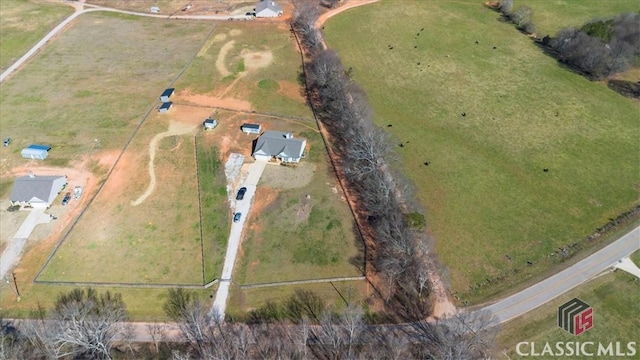 birds eye view of property featuring a rural view