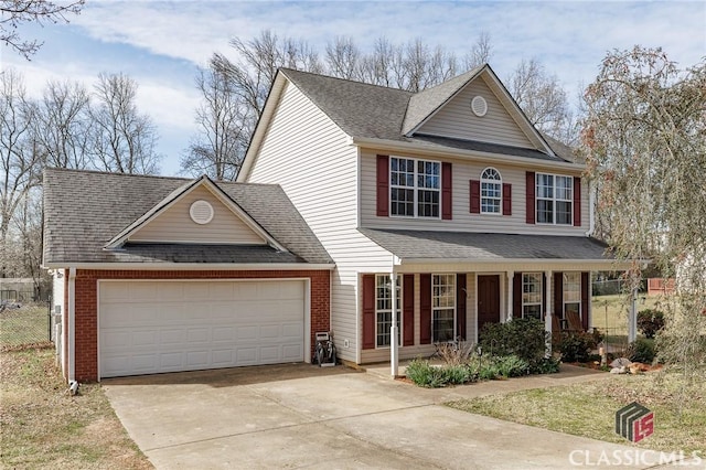 view of front facade featuring brick siding, a shingled roof, covered porch, an attached garage, and driveway