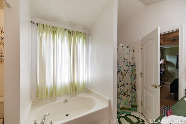 full bath featuring a garden tub, a textured ceiling, and a shower with shower curtain