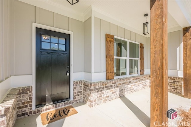 entrance to property featuring board and batten siding and covered porch