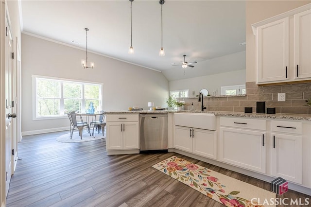 kitchen featuring backsplash, white cabinets, stainless steel dishwasher, ceiling fan with notable chandelier, and wood finished floors