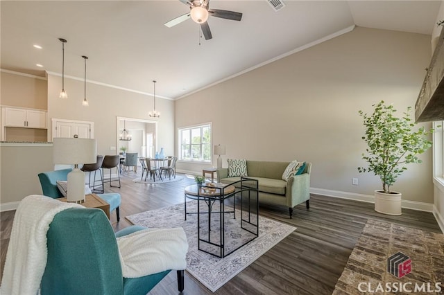 living area with high vaulted ceiling, dark wood-style flooring, ceiling fan with notable chandelier, and ornamental molding