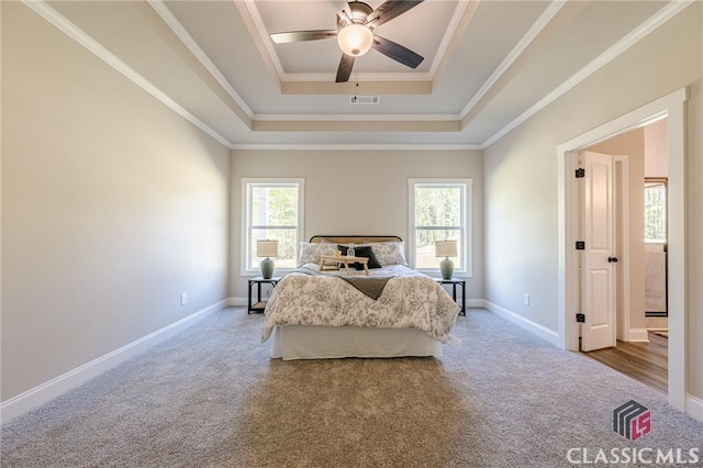 bedroom featuring visible vents, baseboards, multiple windows, and carpet