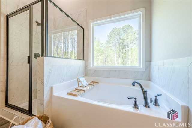 full bath featuring a bath and a stall shower