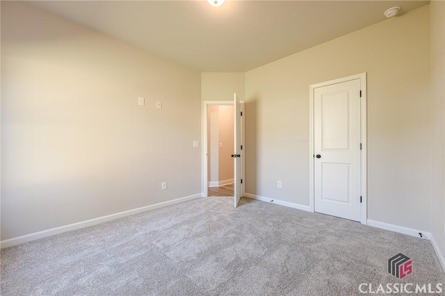 unfurnished bedroom featuring baseboards and carpet flooring