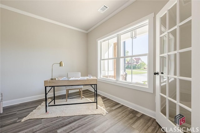office area with crown molding, wood finished floors, baseboards, and visible vents