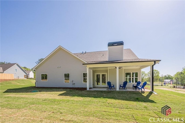rear view of property with a patio area, french doors, a ceiling fan, and a yard