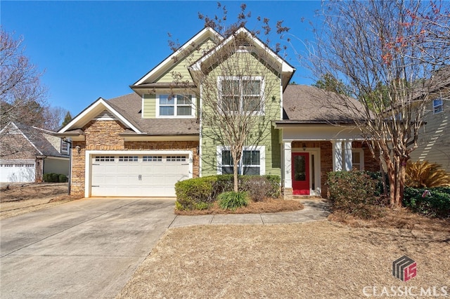 craftsman inspired home featuring a shingled roof, stone siding, and driveway