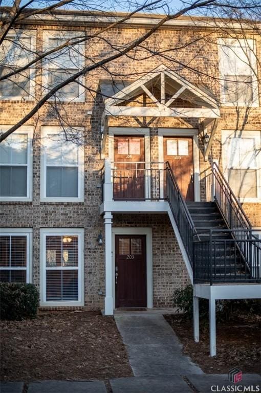 entrance to property featuring brick siding