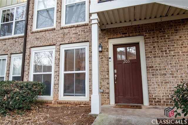 entrance to property with brick siding