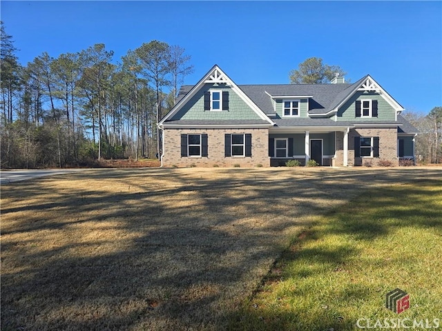 craftsman-style house with brick siding and a front yard