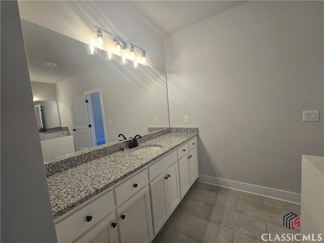 bathroom with tile patterned floors, vanity, and baseboards