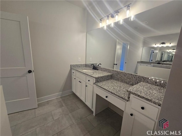 bathroom featuring a sink and baseboards