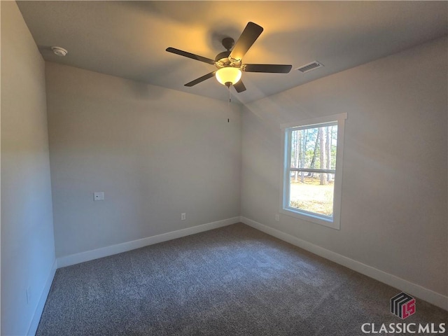 unfurnished room with carpet floors, visible vents, ceiling fan, and baseboards