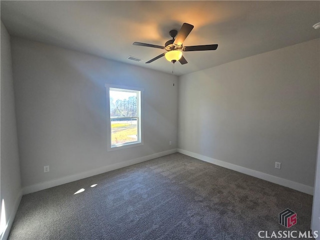 empty room featuring visible vents, carpet flooring, a ceiling fan, and baseboards