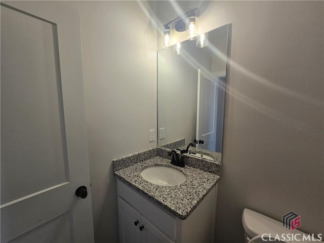 bathroom with vanity and toilet