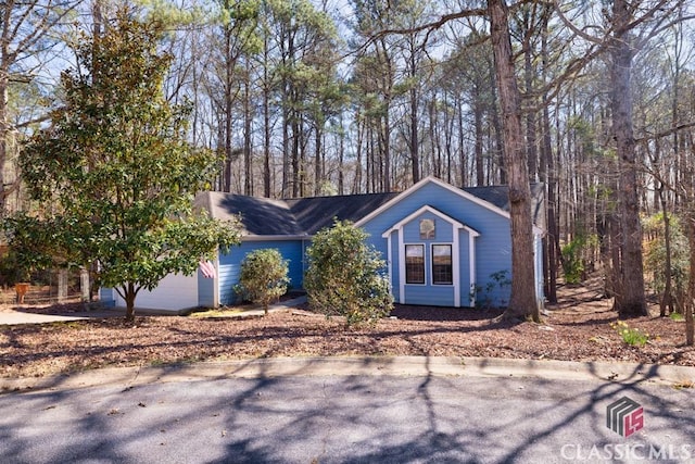 view of front facade with concrete driveway and an attached garage