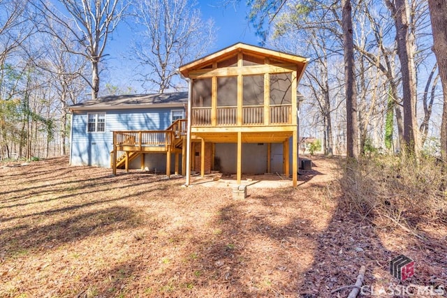 back of house featuring a sunroom, central AC, stairway, and a wooden deck