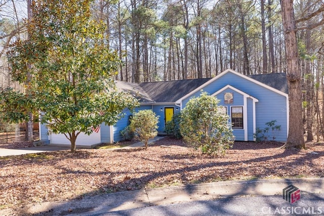 ranch-style home with a garage and concrete driveway