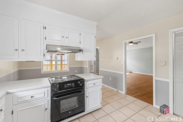 kitchen with light tile patterned floors, black range with electric stovetop, white cabinets, and under cabinet range hood